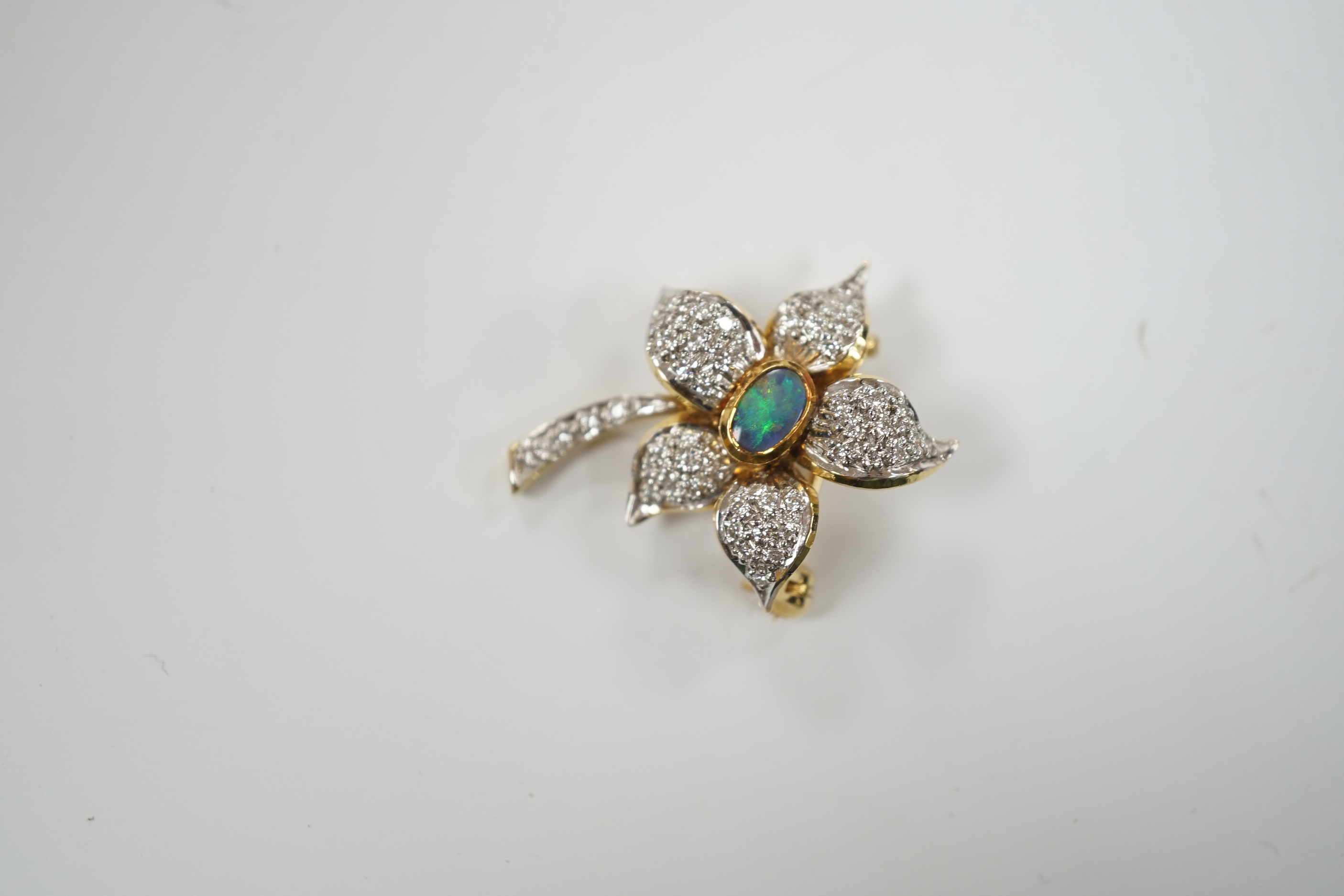 A modern 750 yellow metal, opal doublet? and diamond chip set flower brooch, 31mm, gross weight 7.3 grams.